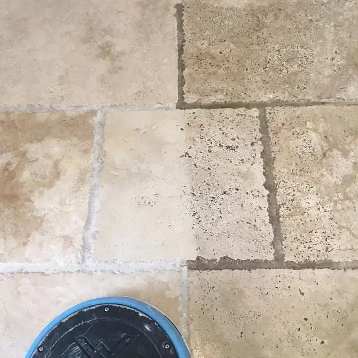 Close-up of tile floor showing a before-and-after deep cleaning result, with a visible contrast between clean and dirty sections.